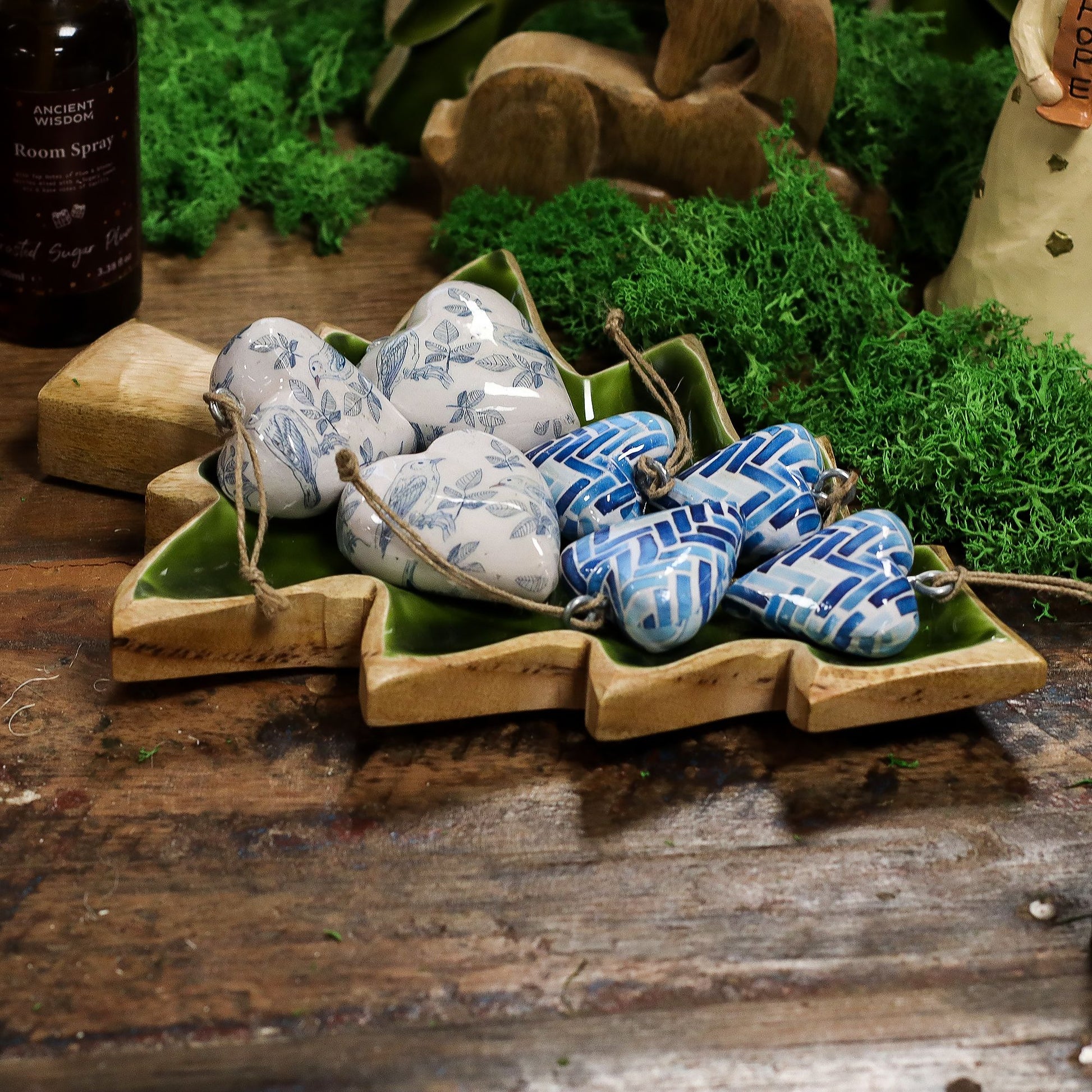 The Enamel Tree Wooden Bowl beautifully arranged with decorative heart-shaped trinkets, exemplifying its versatile use in festive home decor. A delightful option as a Christmas gift for home fragrance enthusiasts.