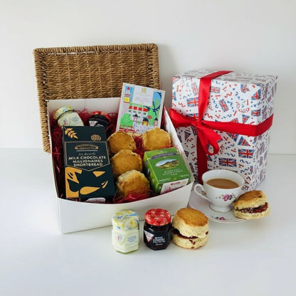 Gift basket with tea, scones, and a mug of tea on a white background