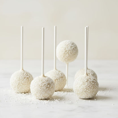 White ivory cream cake pops on sticks with a light background