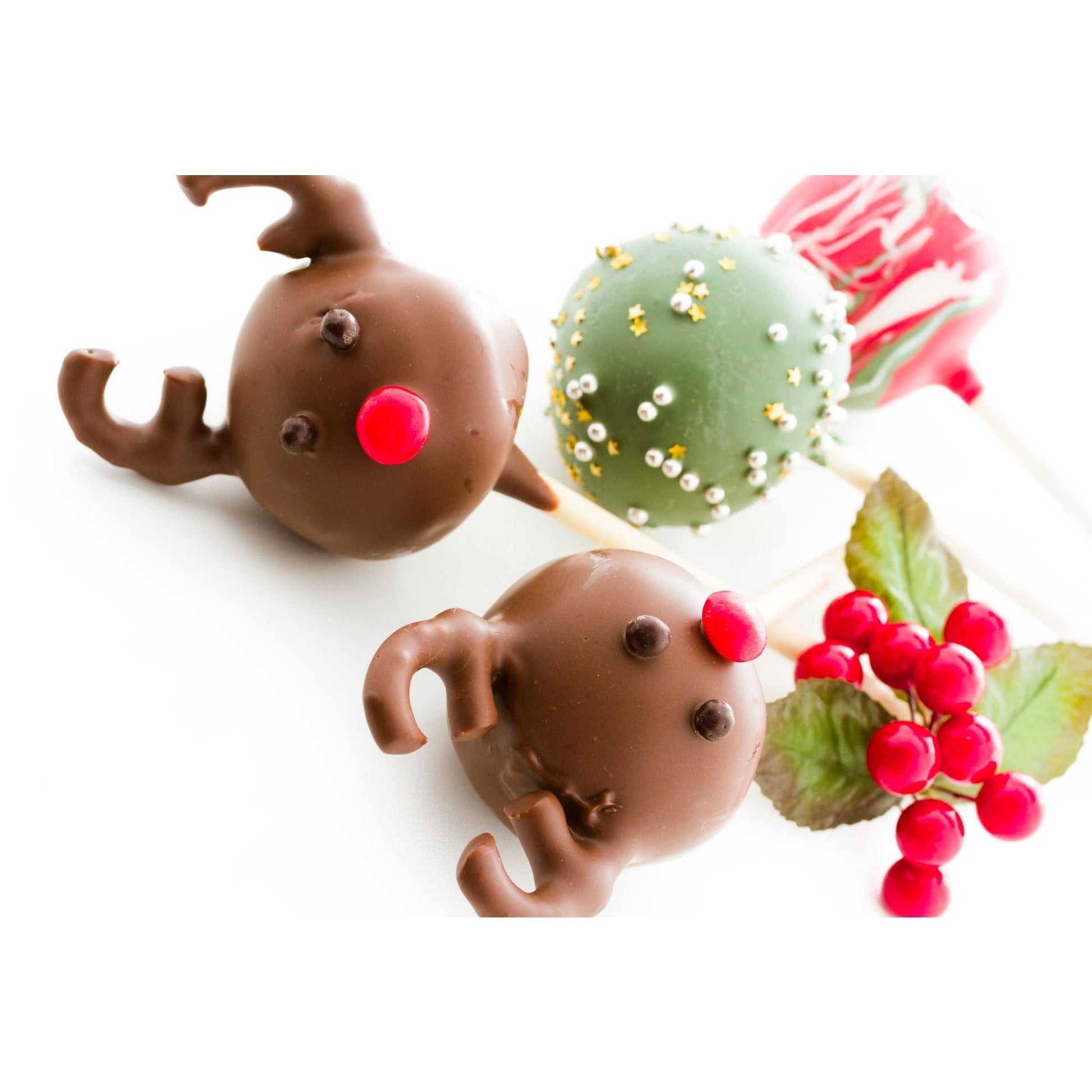 Handmade Christmas reindeer cake pops with chocolate coating and red noses